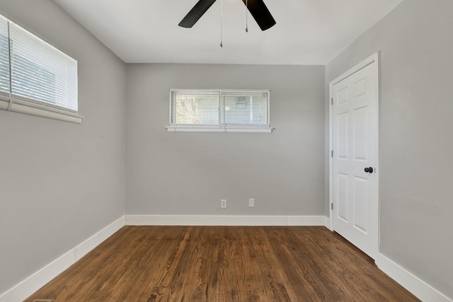 unfurnished room with ceiling fan and dark hardwood / wood-style floors