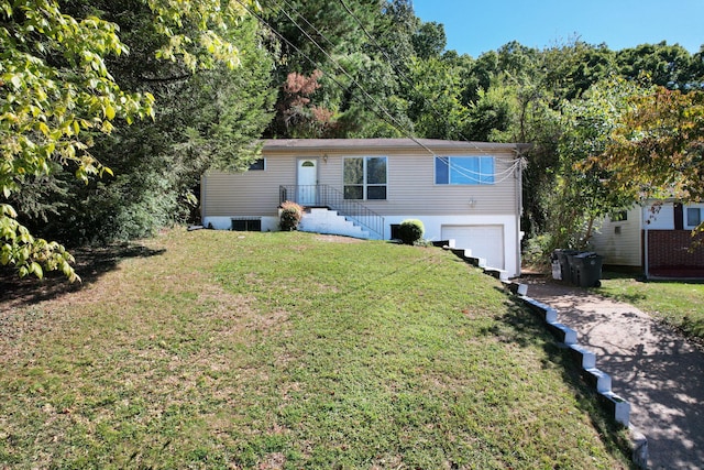 view of front of home featuring a front yard and a garage