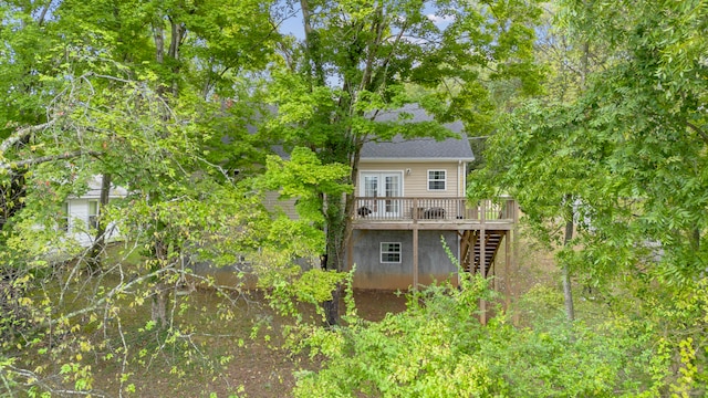 back of house featuring french doors and a deck