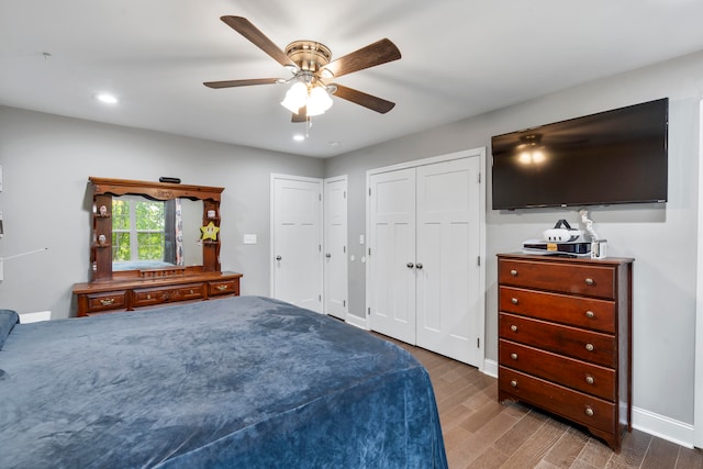 bedroom with ceiling fan and dark hardwood / wood-style floors