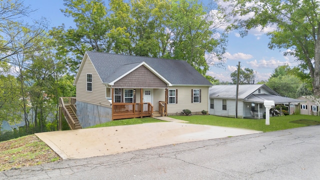 view of front of home with covered porch and a front yard