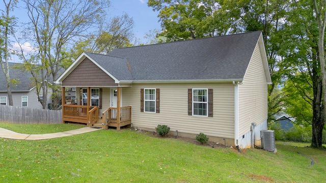 view of front facade featuring central air condition unit and a front yard