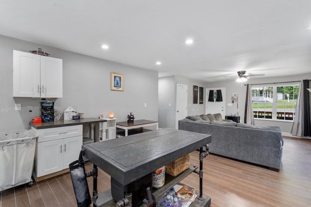 kitchen with white cabinets, light hardwood / wood-style floors, and ceiling fan