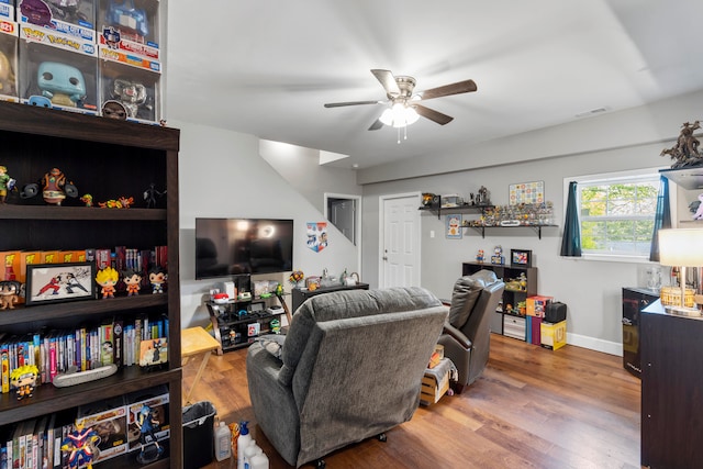 living room featuring wood-type flooring and ceiling fan