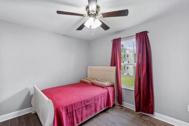 bedroom with ceiling fan and dark hardwood / wood-style floors