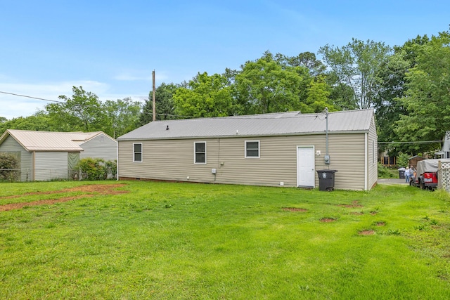 922 Barnabas St, Athens, TN 37303 - back of house featuring a yard, metal roof, and view of scattered trees
