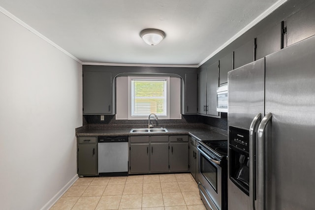 922 Barnabas St, Athens, TN 37303 - kitchen featuring stainless steel appliances, dark countertops, a sink, light tile patterned flooring, and crown molding