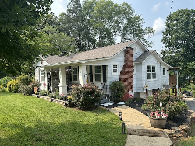 1785 Benton Station Rd, Benton, TN 37307 - view of front facade featuring roof with shingles, a porch, and a front yard