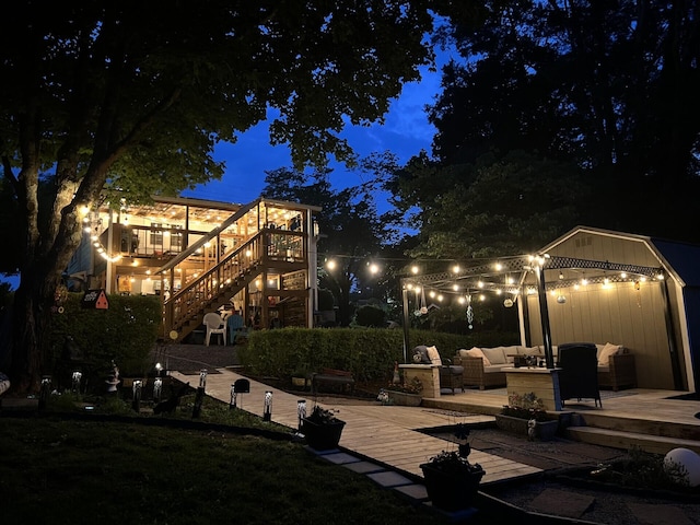 1785 Benton Station Rd, Benton, TN 37307 - patio at twilight featuring a deck, an outdoor living space, and stairs