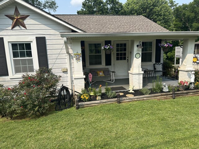 1785 Benton Station Rd, Benton, TN 37307 - view of front of property featuring a shingled roof, covered porch, and a front lawn