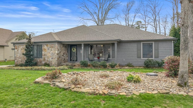 single story home featuring stone siding, a shingled roof, a front lawn, and a porch