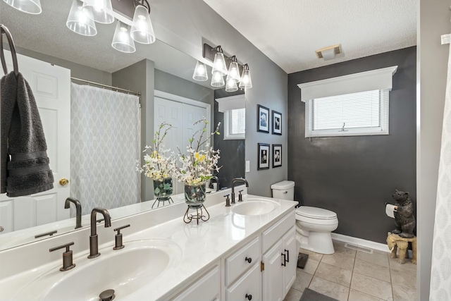 full bath featuring visible vents, toilet, a sink, and a textured ceiling