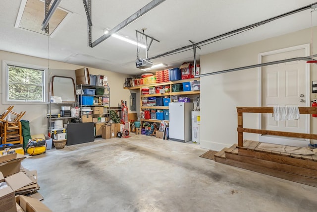 garage featuring water heater and a garage door opener