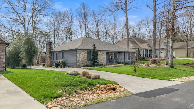 view of front facade featuring a chimney, a front yard, stone siding, and curved driveway