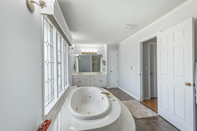 full bathroom featuring vanity, crown molding, a textured ceiling, and a wealth of natural light
