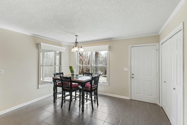 dining room featuring baseboards, ornamental molding, a notable chandelier, and dark tile patterned floors