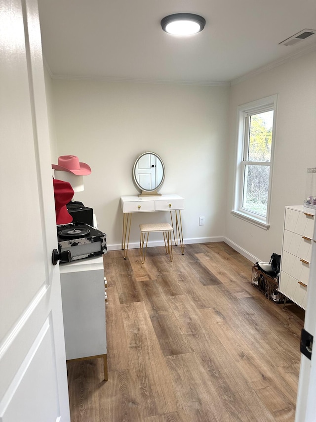 interior space with crown molding and hardwood / wood-style flooring