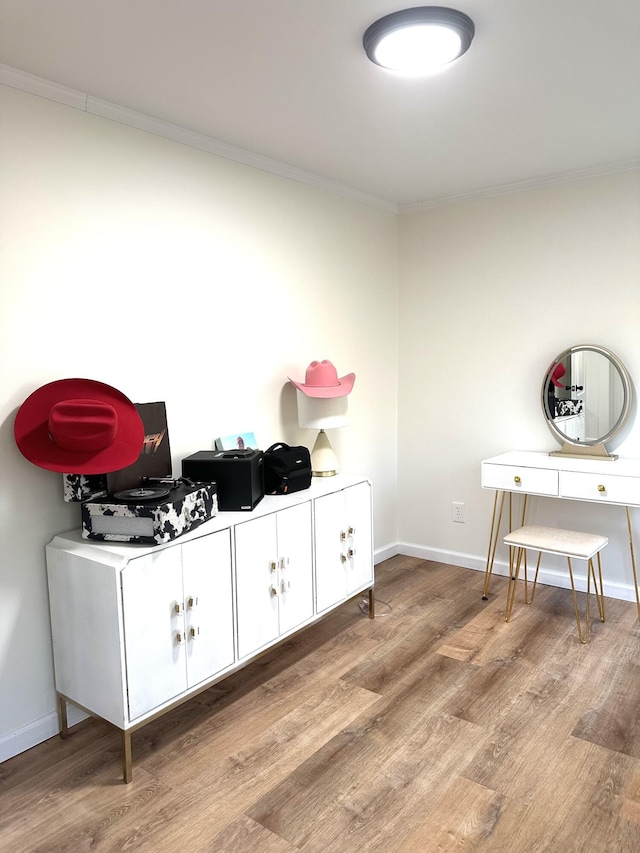 interior space with hardwood / wood-style flooring and crown molding