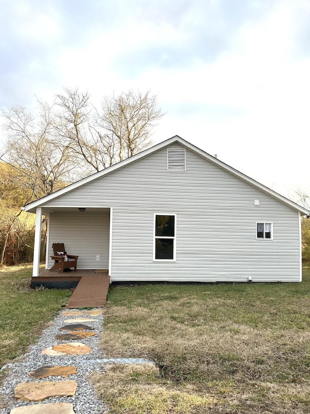 view of side of home with a lawn