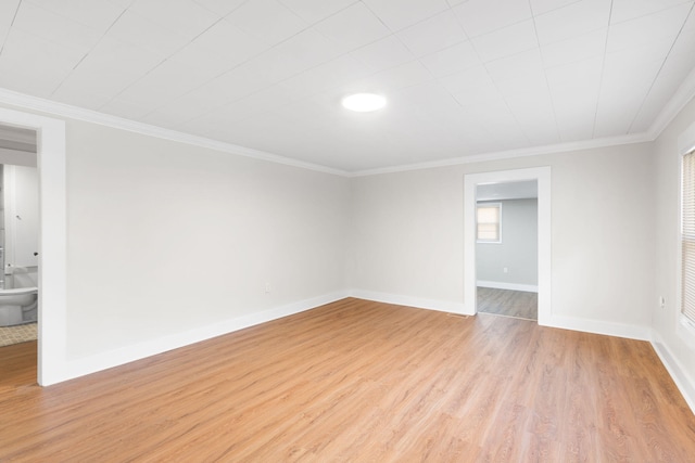 empty room featuring light hardwood / wood-style floors and crown molding