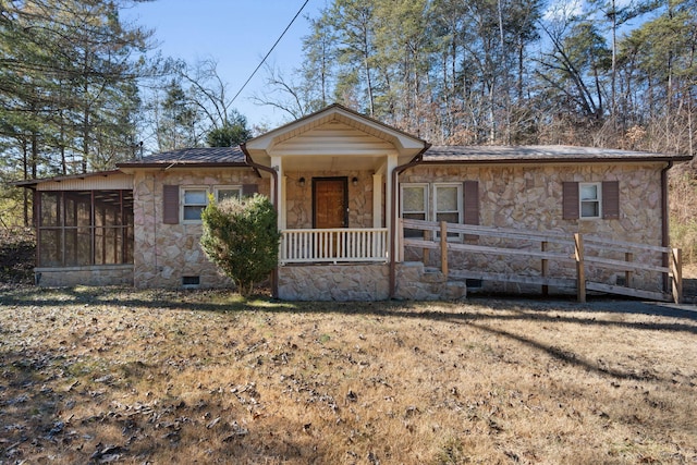 view of front facade featuring a front yard and a sunroom