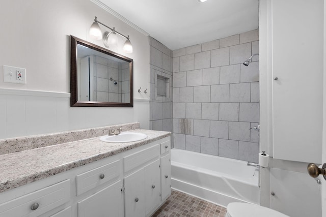 full bathroom with toilet, vanity, and tiled shower / bath