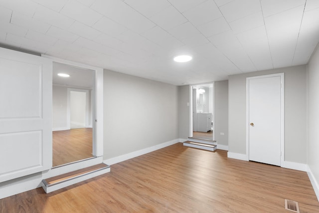 basement with light hardwood / wood-style floors