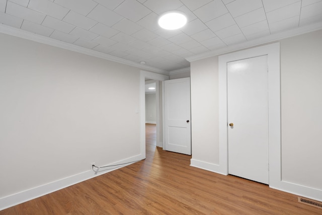 interior space featuring ornamental molding, light hardwood / wood-style flooring, and a closet