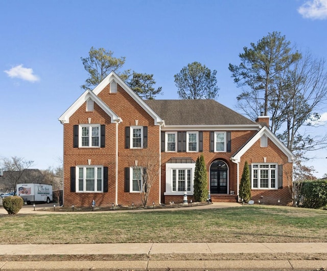 view of front facade with french doors and a front lawn