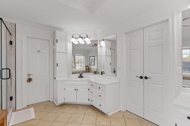 bathroom featuring crown molding, vanity, a shower with shower door, and tile patterned flooring