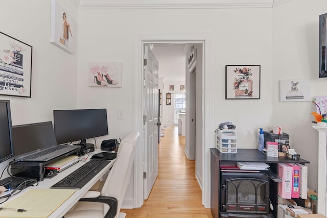 office area with ornamental molding and light hardwood / wood-style floors