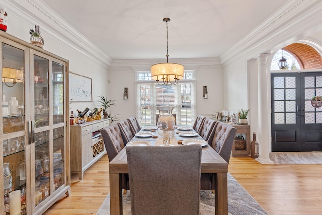 dining space featuring a wealth of natural light, a notable chandelier, and light hardwood / wood-style flooring