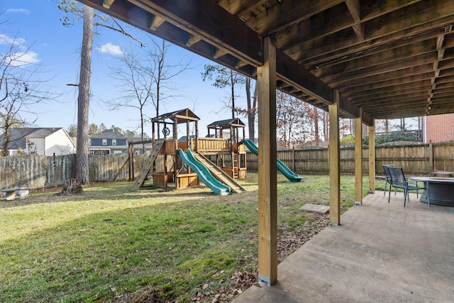 view of playground featuring a yard and a patio area