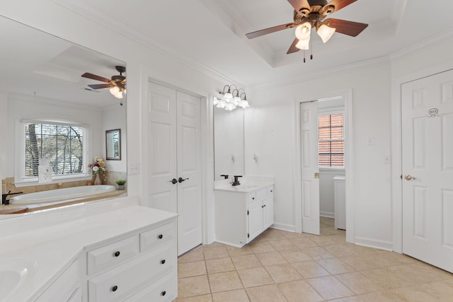 bathroom featuring tile patterned floors, ornamental molding, a raised ceiling, and vanity