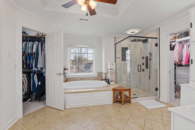 bathroom with tile patterned flooring, shower with separate bathtub, ornamental molding, and a raised ceiling