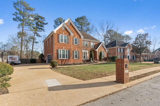 view of front of house featuring a garage and a front lawn