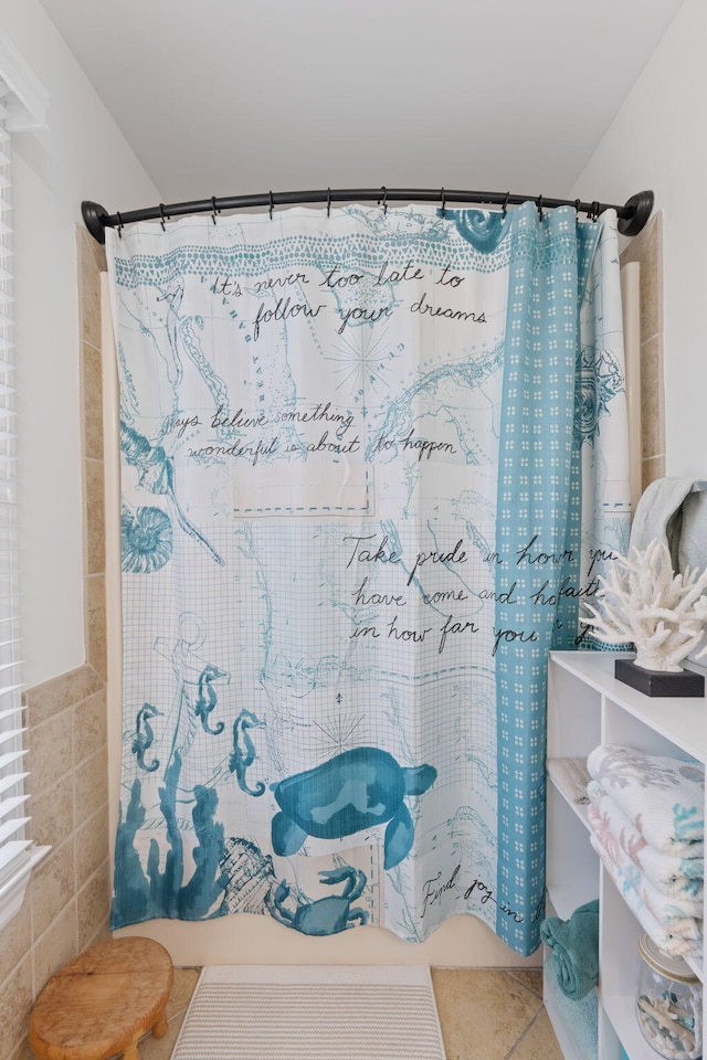 bathroom with tile patterned flooring, tile walls, and a shower with shower curtain