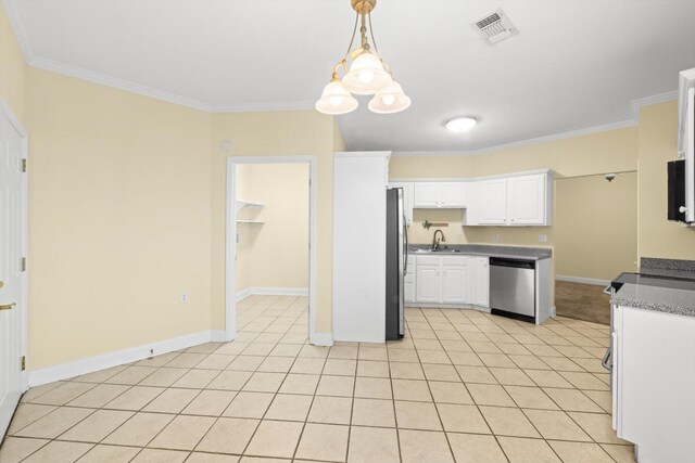 1015 Crestway Dr, Athens, TN 37303 - kitchen with appliances with stainless steel finishes, crown molding, white cabinetry, light tile patterned floors, and baseboards