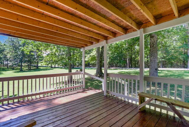 wooden terrace with a lawn