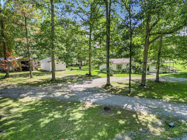 surrounding community with an outbuilding and a yard