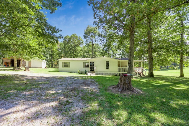 view of yard with covered porch and a storage unit