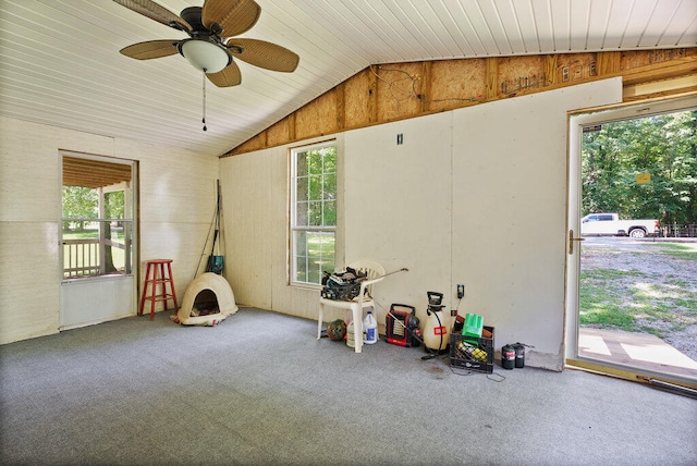 recreation room with lofted ceiling, ceiling fan, and wooden walls