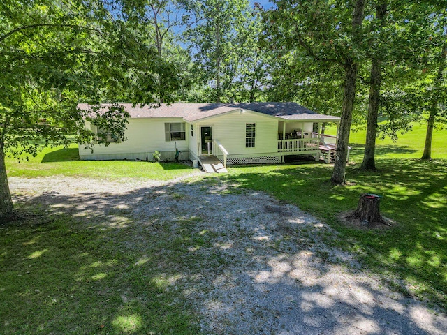 rear view of property featuring a lawn