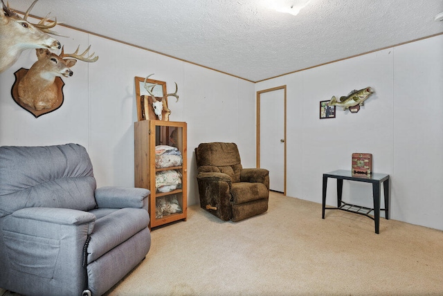 sitting room with carpet flooring, a textured ceiling, and ornamental molding