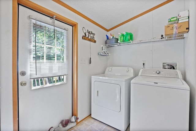 washroom featuring washer and dryer, a textured ceiling, and crown molding