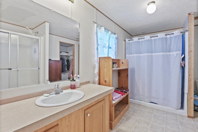 bathroom with vanity, a textured ceiling, and shower / tub combo with curtain