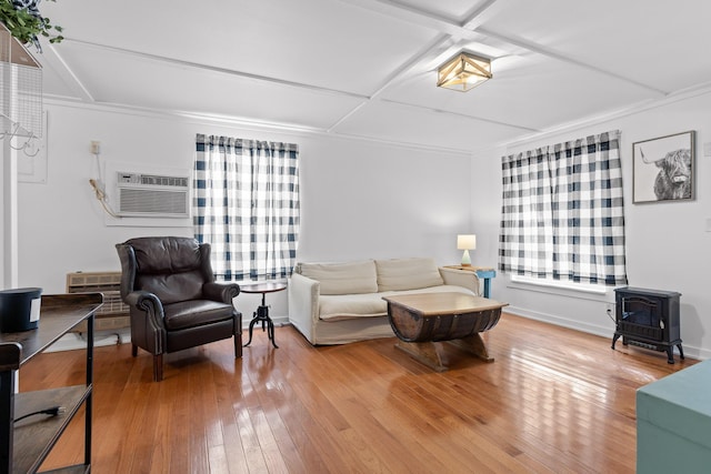 living room featuring a wood stove, hardwood / wood-style flooring, and a wall mounted AC