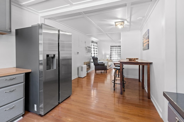 kitchen with gray cabinets, light hardwood / wood-style floors, coffered ceiling, and stainless steel refrigerator with ice dispenser