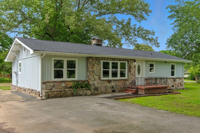 2207 Spencer Ave, Chattanooga, TN 37421 - single story home with stone siding, a chimney, a shingled roof, a front yard, and board and batten siding