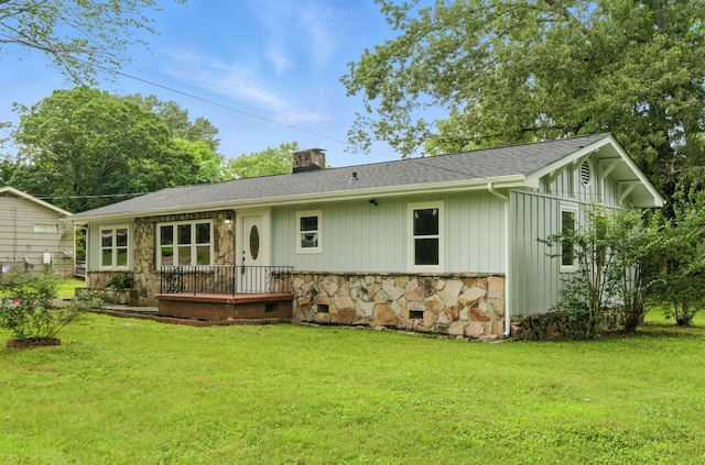 2207 Spencer Ave, Chattanooga, TN 37421 - back of property with stone siding, a chimney, and a lawn